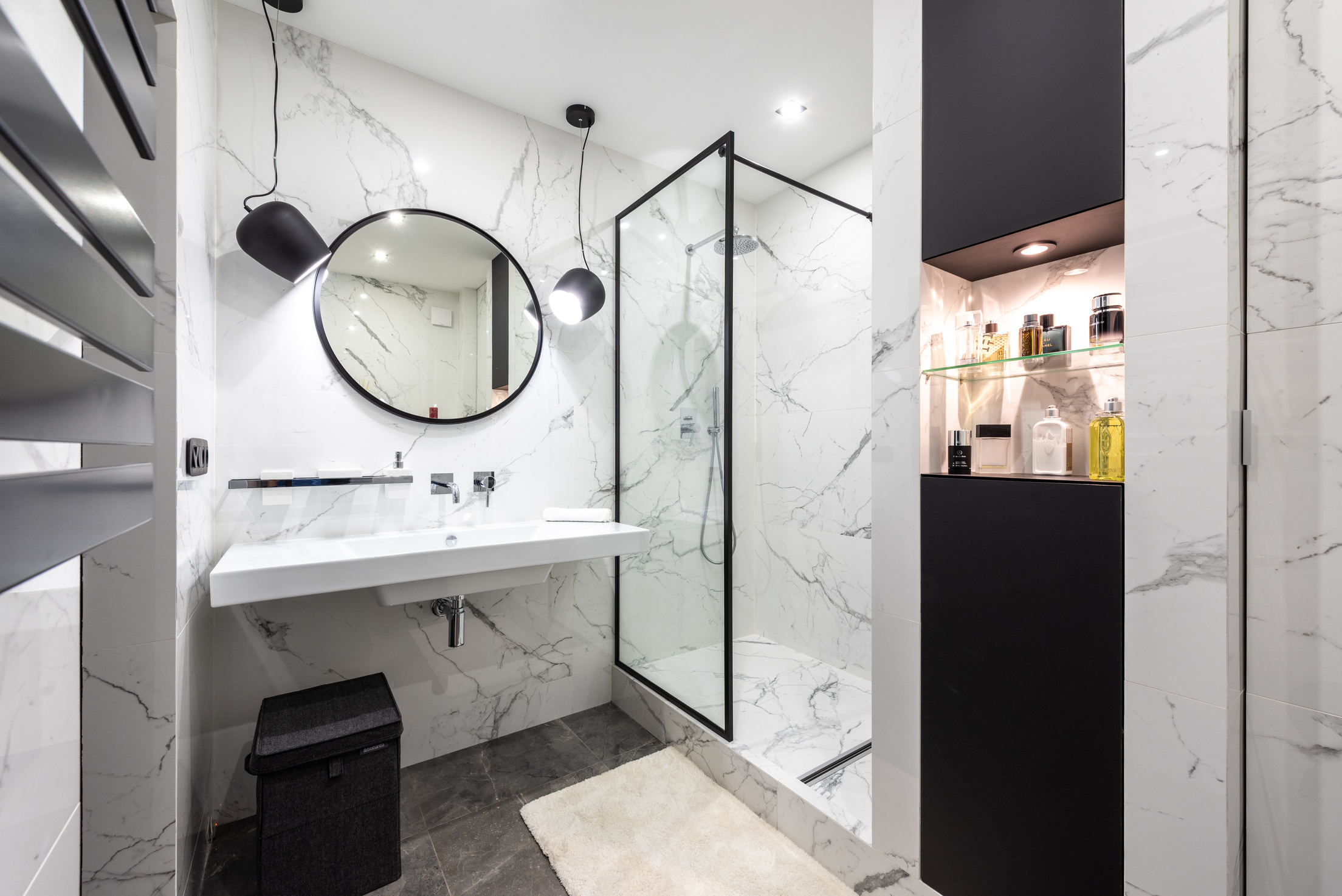 Modern bathroom interior with mirror between lamps at home